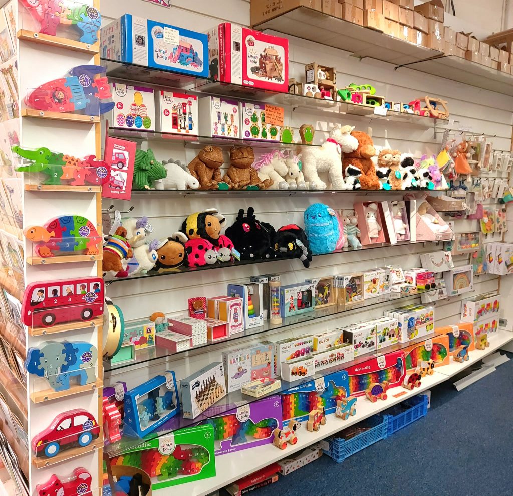 Shelves of wooden toys and plush animals in our Grantham toy shop